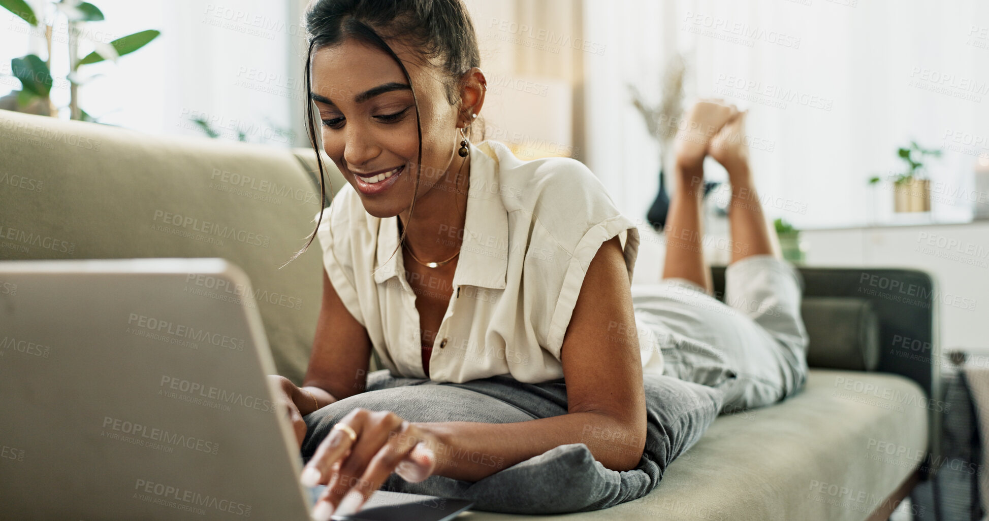 Buy stock photo Woman, remote work and relax on sofa with laptop to update blog post, social media or digital subscription. Happy indian freelancer, lounge and computer for online shopping, elearning or typing email