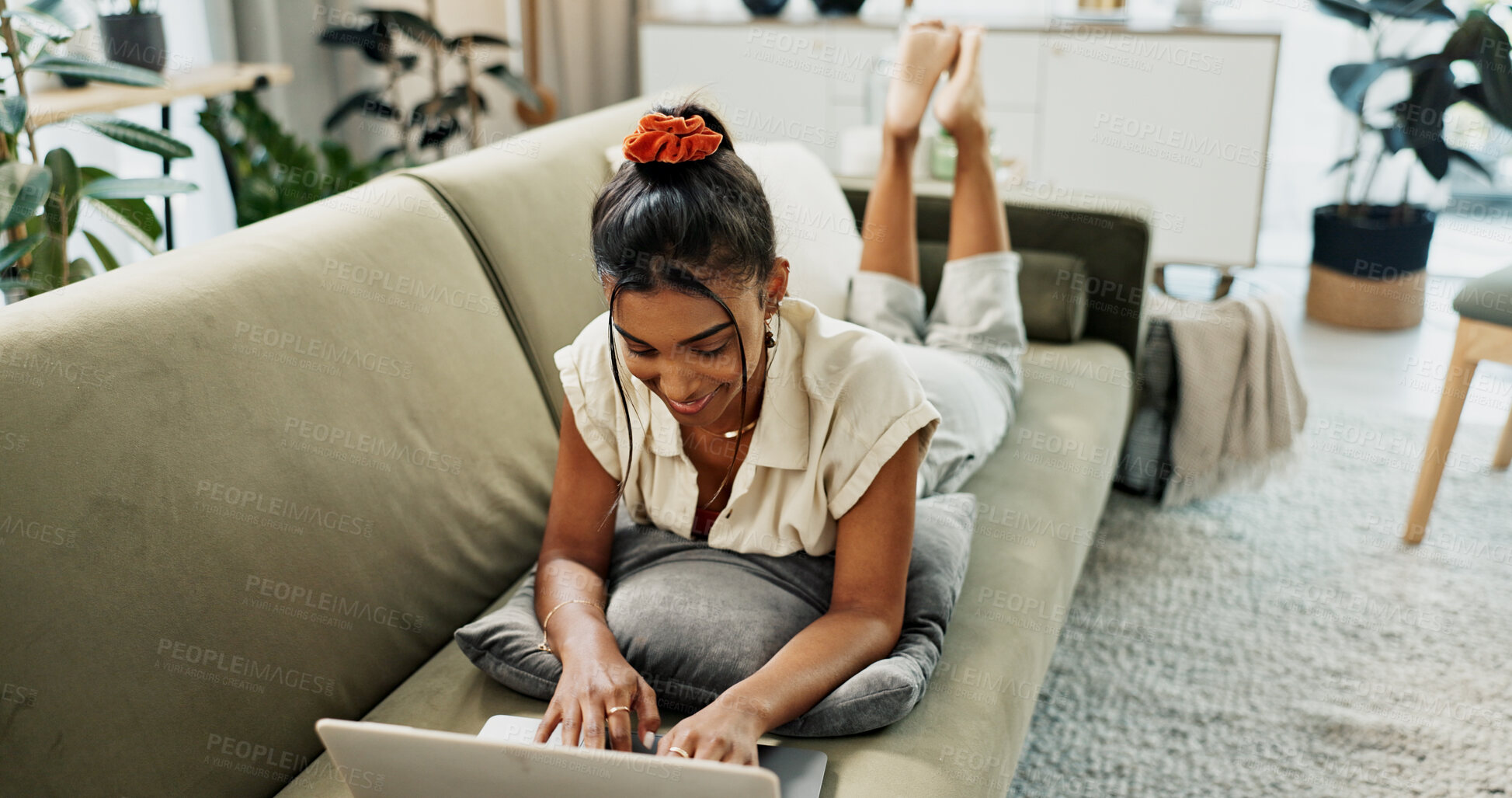 Buy stock photo Woman, remote work and relax with laptop in living room to update blog post, social media and website subscription. Happy indian freelancer at computer for online shopping, elearning and typing email