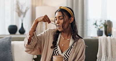 Woman, eating ice cream and home on couch, thinking or idea for dessert, sweets or relax in living room. Girl, gelato or frozen yogurt for snack, lounge sofa and house with memory, choice or decision