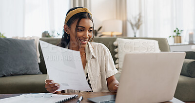 Woman, work from home and documents on laptop for online research, financial planning and data report. Young worker or freelancer typing on her computer with paperwork, bills and taxes in living room