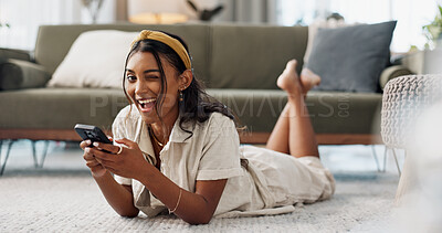Woman, phone and portrait with wink, relax and lying on floor for flirting, secret and typing in living room of home. Indian, girl and smartphone on ground for chat, texting or technology with emoji