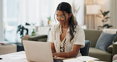Buy stock photo Laptop, remote work and woman typing for research in the living room of modern apartment. Smile, technology and young Indian female freelancer working on creative project with computer at home.