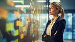 Woman looking and brainstorming with ideas on glass board and sticky note