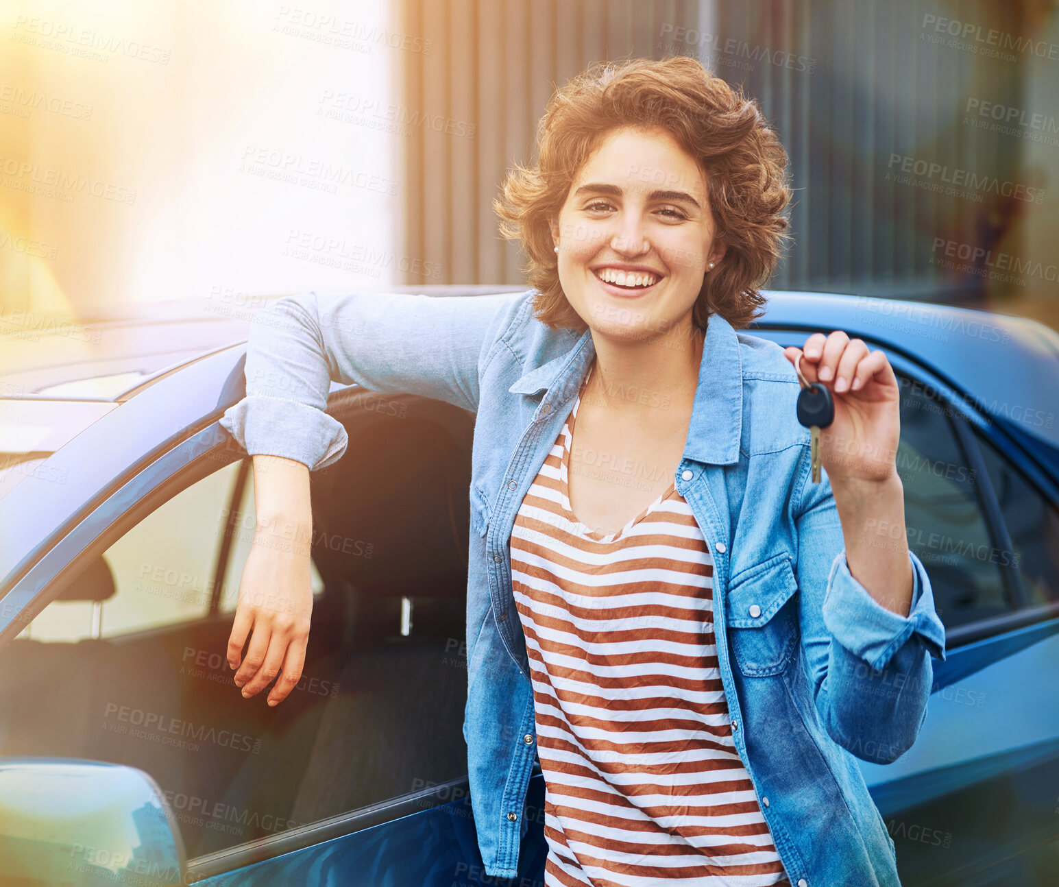 Buy stock photo Shot of a happy young woman holding the keys to a new car