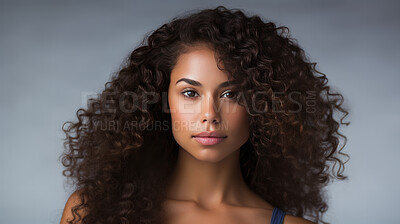 Portrait of young woman with dark natural curly hair. Hair care, make-up and hair health