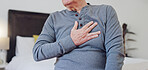 Hands, chest pain and closeup of senior man in bedroom with injury, hurt or accident at nursing home. Sick, ill and zoom of elderly male person in retirement with asthma or heart attack at house.