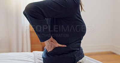 Senior woman, back pain and home bedroom with muscle problem and arthritis in retirement. Elderly patient, osteoporosis and injury on a bed with hands holding for support of inflammation with crisis