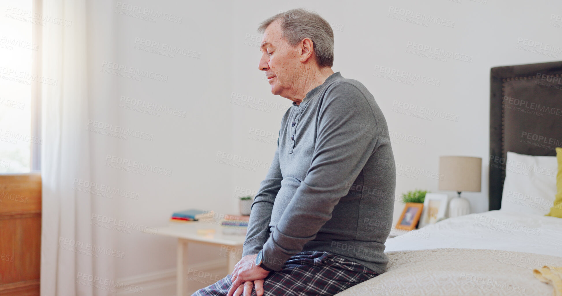 Buy stock photo Senior man, thinking and lonely in bedroom with depression, anxiety or mental health in retirement. Tired, elderly person and remember grief or loss in morning, home or sad in the house with a memory