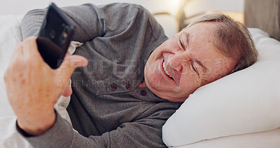Buy stock photo Happy, senior man and reading with phone in bedroom or streaming funny, comedy or meme on social media. Elderly person, smile or relax with cellphone at night in bed with communication or online chat