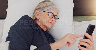 Buy stock photo Phone, relax and senior woman in bed networking on social media, mobile app or internet. Technology, rest and elderly female person in retirement scroll on website with cellphone in bedroom at home.