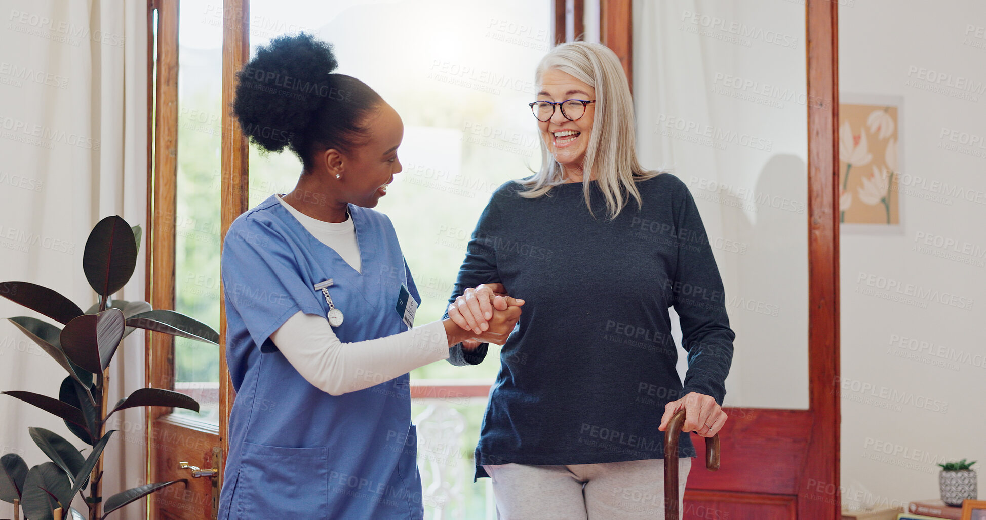 Buy stock photo Senior woman, nurse and help with walking stick for rehabilitation, wellness and talk with smile. African caregiver, happy patient and elderly person with disability, cane and support for recovery