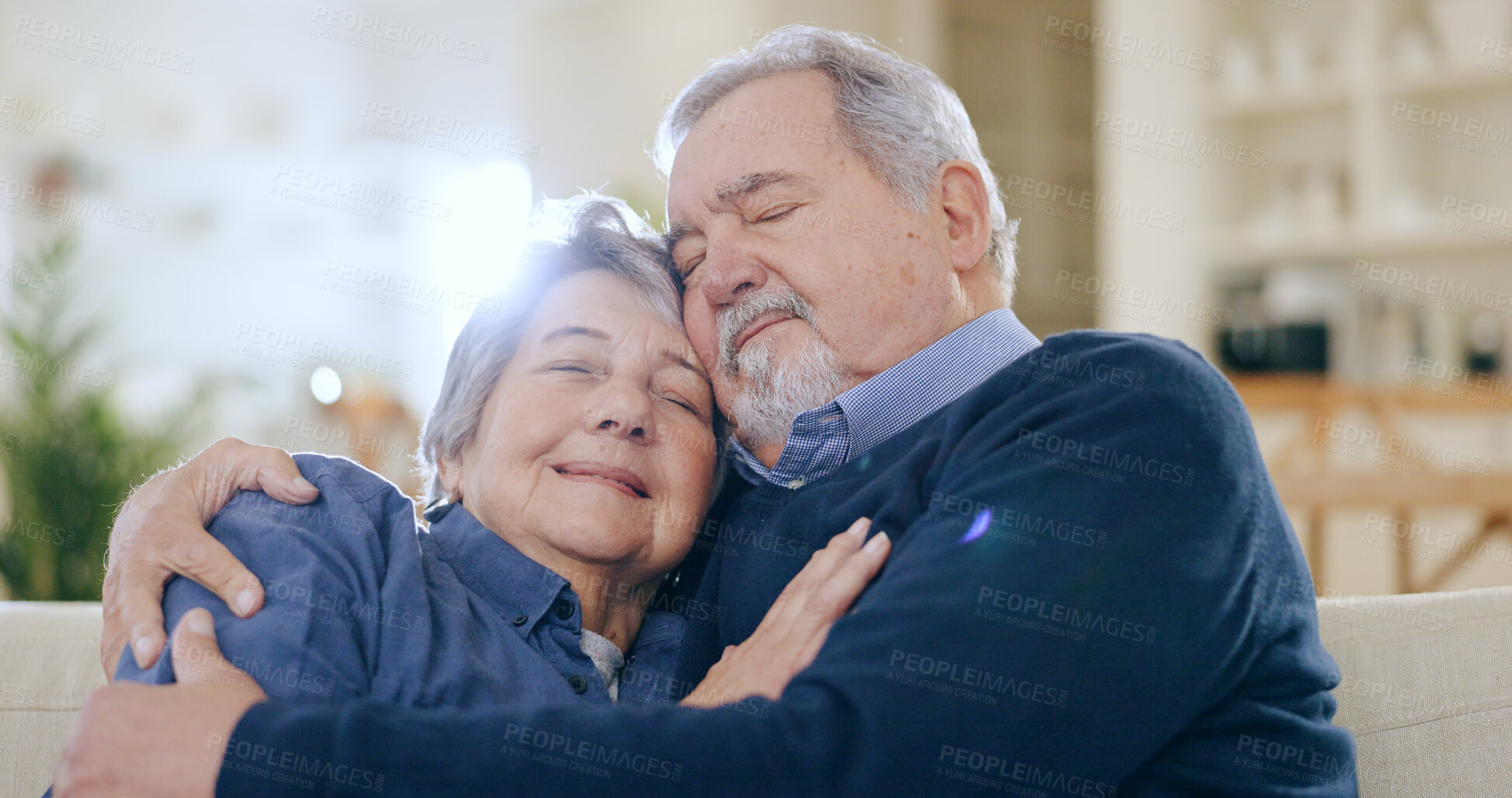 Buy stock photo Home, hug and senior couple on a couch, love and happiness with relationship in a living room. Romance, old man and elderly woman on a sofa, support and funny with embrace, retirement and marriage