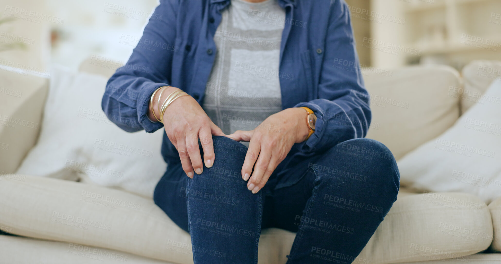 Buy stock photo Home, injury and senior woman with knee pain, massage and inflammation in a living room. Pensioner, old person and elderly lady on a couch, accident or emergency with bruise, broken or muscle tension