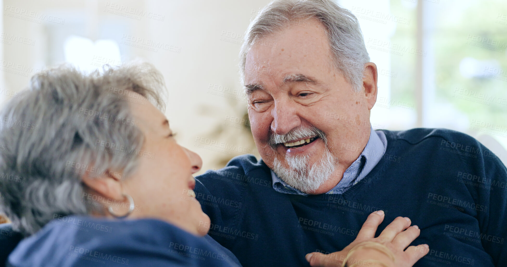 Buy stock photo Home, conversation and senior couple on a couch, funny and happiness with retirement in a living room. Romance, old man and elderly woman with love, support and funny with discussion and laughing