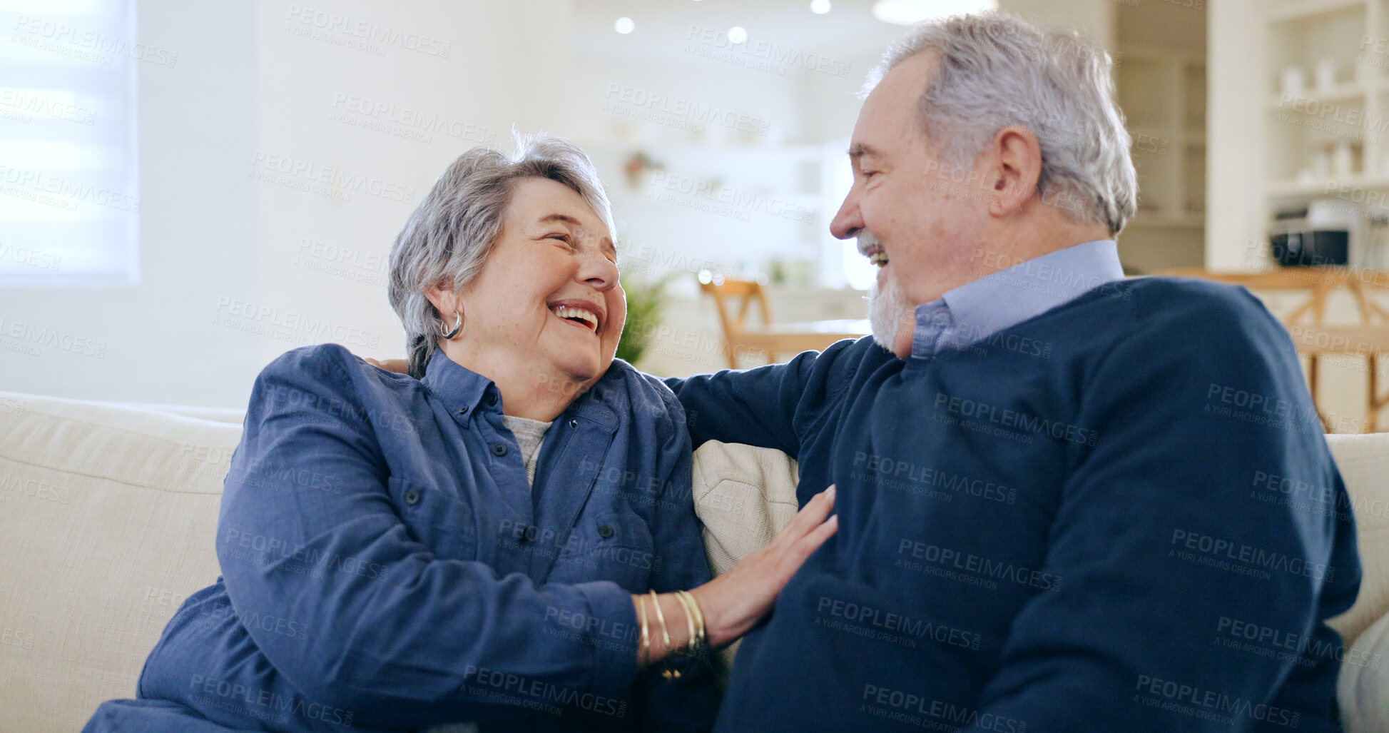 Buy stock photo Home, conversation and senior couple on a couch, love and happiness with retirement in a living room. Romance, old man and elderly woman on a sofa, support and funny with humor, laughing and cheerful