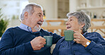 Coffee, love and a senior couple in their home to relax together during retirement for happy bonding. Smile, romance or conversation with an elderly man and woman drinking tea in their living room