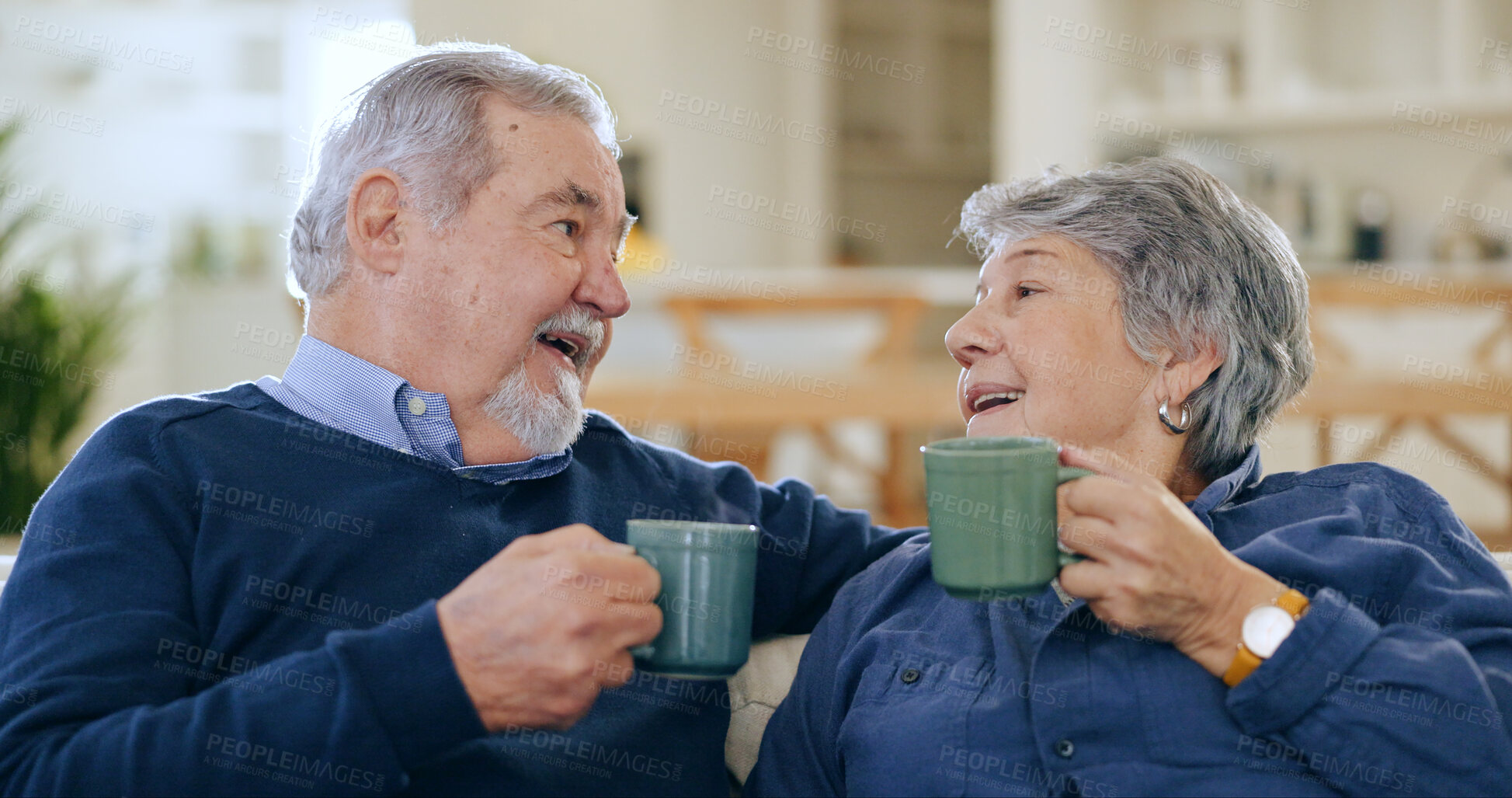Buy stock photo Coffee, love and a senior couple in their home to relax together during retirement for happy bonding. Smile, romance or conversation with an elderly man and woman drinking tea in their living room