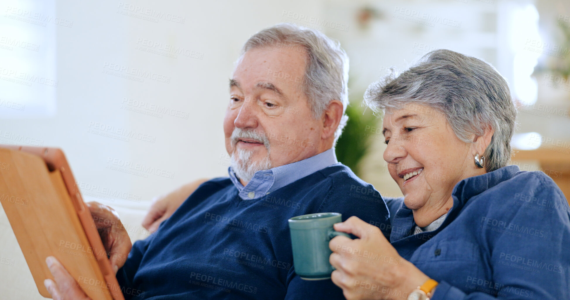 Buy stock photo Tablet, tea and a senior couple in their home to relax together during retirement for happy bonding. Tech, smile or love with an elderly man and woman drinking coffee in their apartment living room