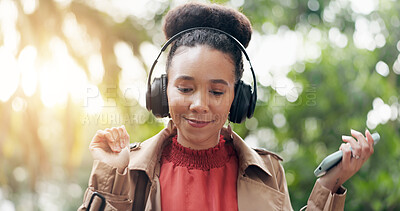 Happy woman, phone and headphones in nature for music, audio streaming or outdoor sound track. Female person smile with technology on smartphone listening to podcast, playlist or songs at park