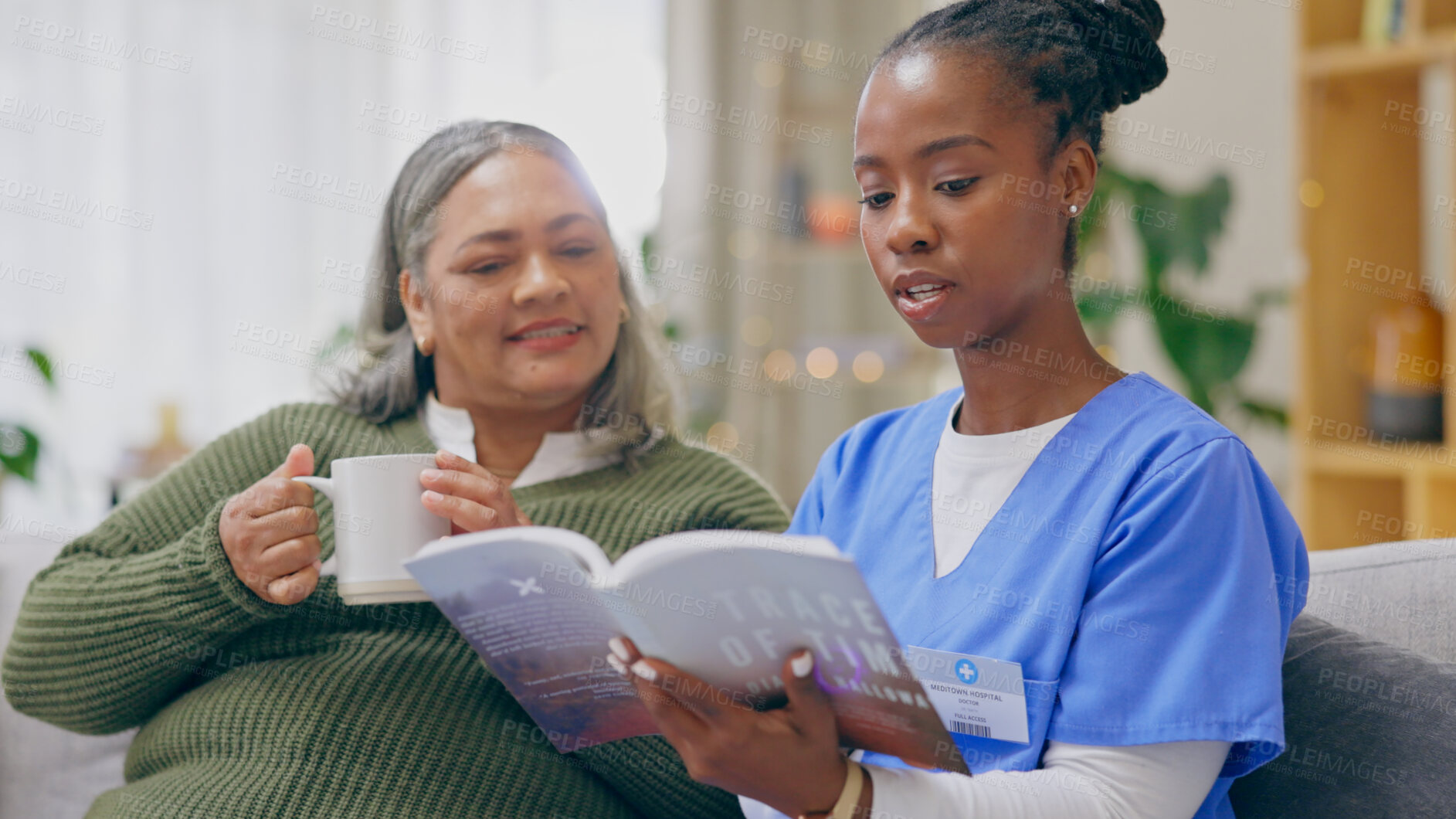 Buy stock photo Coffee, reading book or senior patient with nurse on sofa for nursing home, retirement or house. Healthcare, tea or elderly lady with caregiver, black woman or volunteer in hospice for rehabilitation