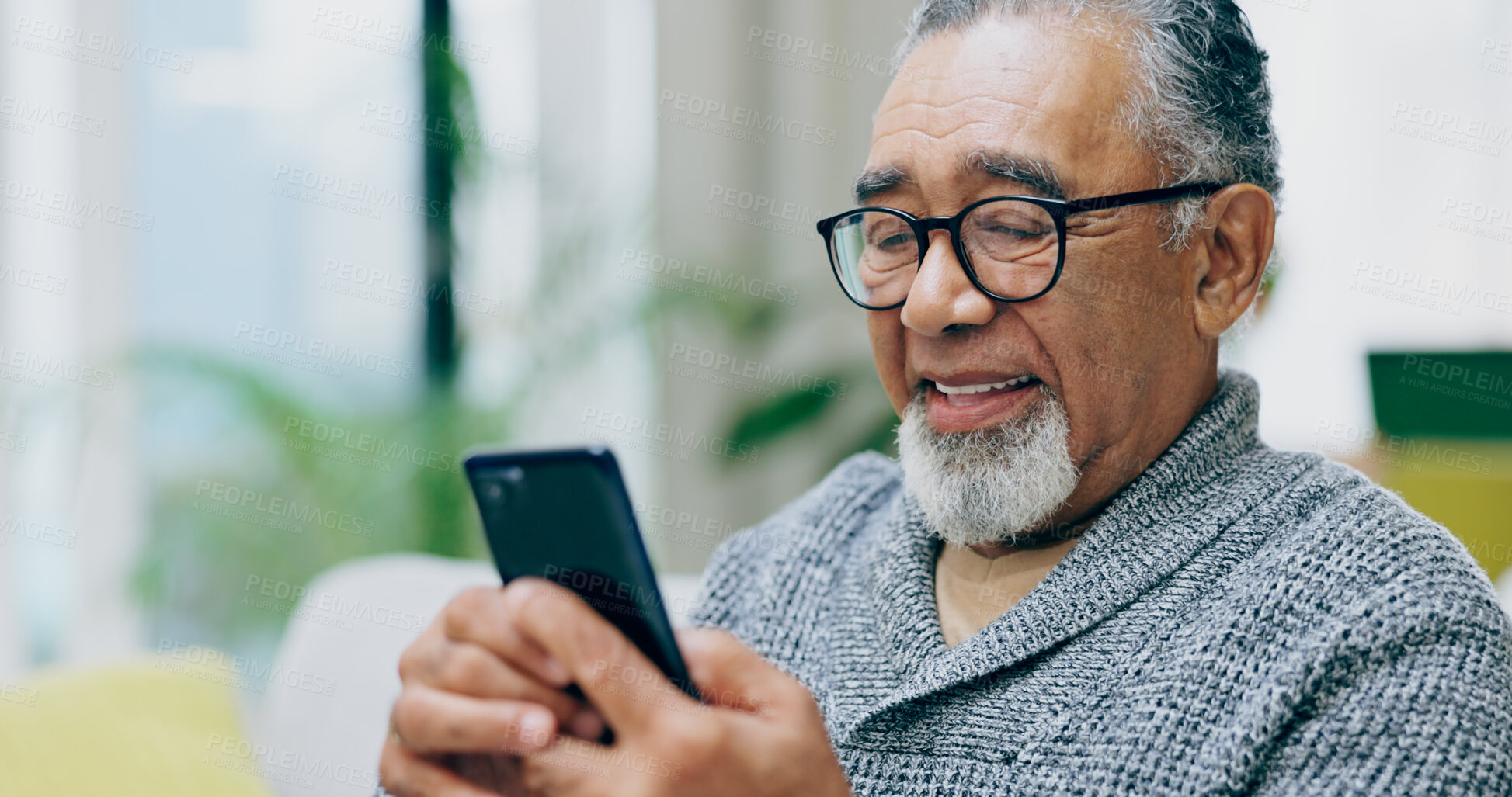 Buy stock photo Senior man, smile and phone on sofa with texting, reading or click for contact in home living room. Elderly person, smartphone and happy for notification, social network app or relax on lounge couch