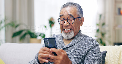 Senior man, happy and phone on couch for texting, reading or thinking for contact in home living room. Elderly person, smartphone and smile for notification, social media app and relax on lounge sofa