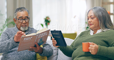 Reading, relax and senior couple on a sofa with book, tablet and coffee while bonding at home together. Literature, ebook and old people chilling in tea in a living room calm and enjoy retirement