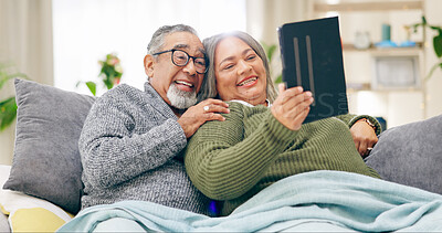 Buy stock photo Tablet, relax and senior couple with retirement, home and marriage with humor, happiness and cheerful. Apartment, elderly woman and old man with tech, calm and relationship with social media and app