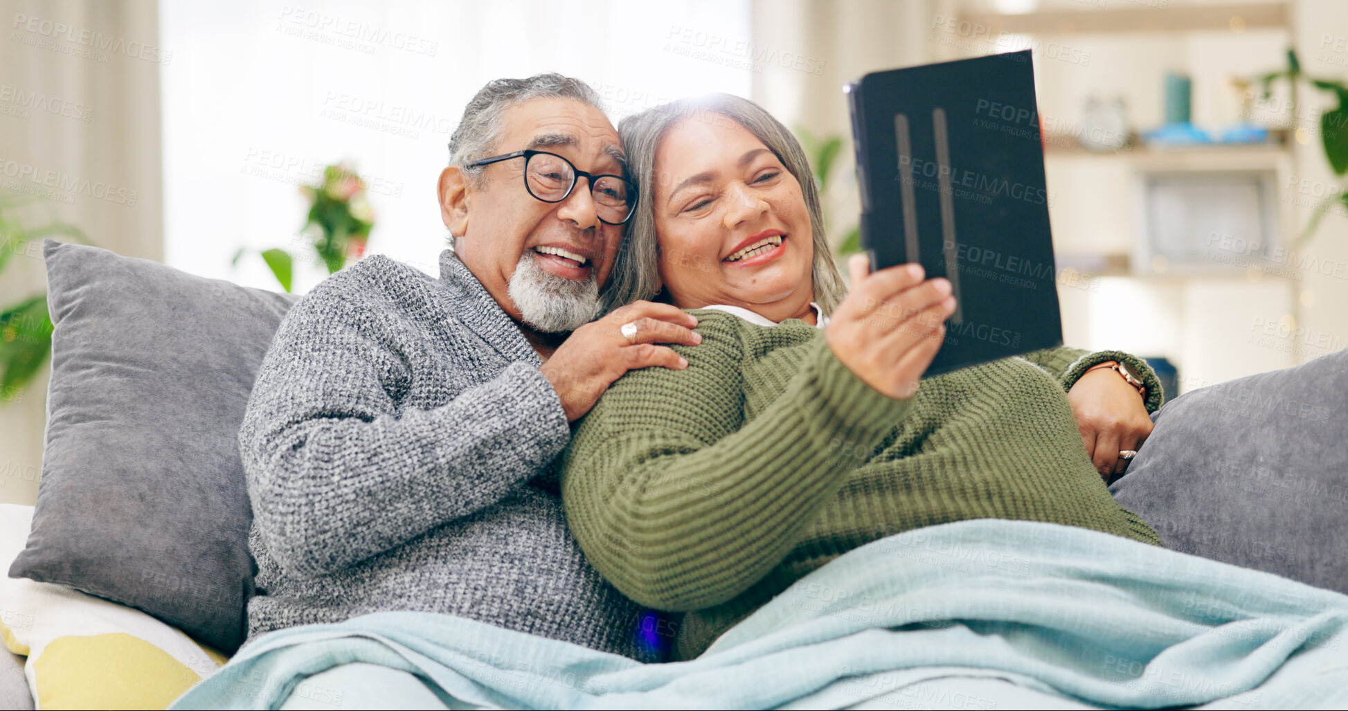 Buy stock photo Tablet, relax and senior couple with retirement, home and marriage with humor, happiness and cheerful. Apartment, elderly woman and old man with tech, calm and relationship with social media and app
