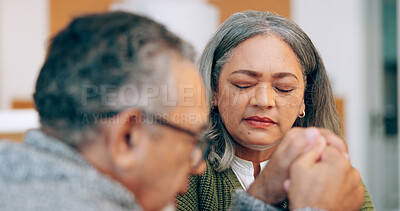 Buy stock photo Hope, holding hands or old couple praying for support, trust or faith in marriage commitment at home. Eyes closed, wellness or senior man bonding with an elderly woman in prayer for peace or worship