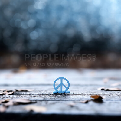 Small peace symbol on table. Blurred, clear backdrop. Peace concept.