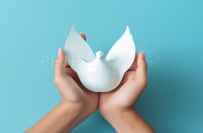 Buy stock photo Hands holding paper dove on blue backdrop. Peace concept.