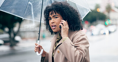 Businesswoman, worry and phone for talking in city for commute to work by walking with umbrella for rain. African person, manager and serious face while late for career, job or meeting with client