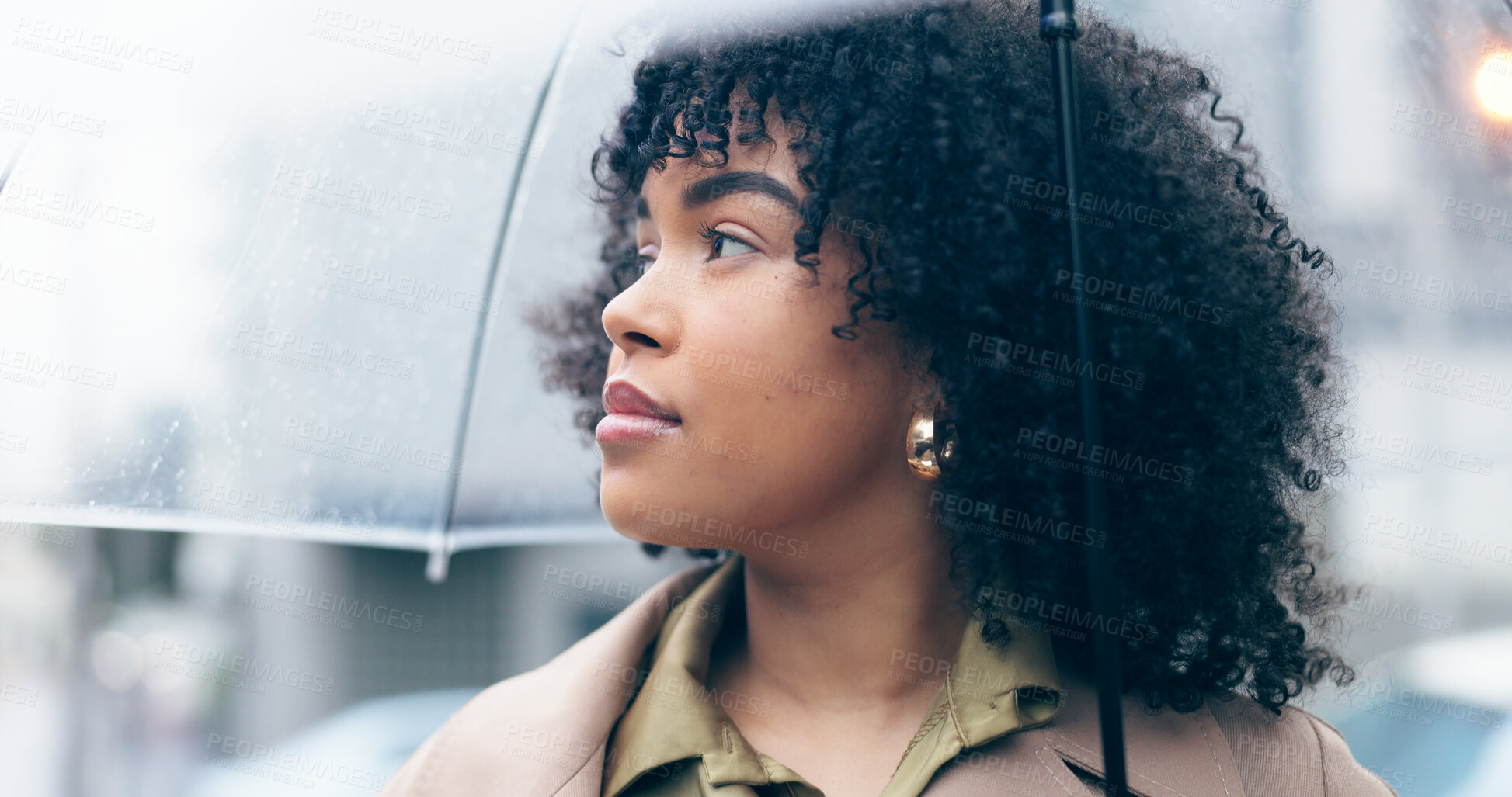 Buy stock photo Woman, rain and thinking outdoor with umbrella for face, weather and safety with travel in urban city. African person, journey or commute  with security, water drops or storm town or street in winter