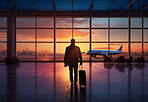 Silhouette of traveller walking to window in airport. Plane in background. Travel concept.