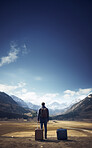Silhouette of traveller standing in the middle of nowhere with luggage.Travel concept.