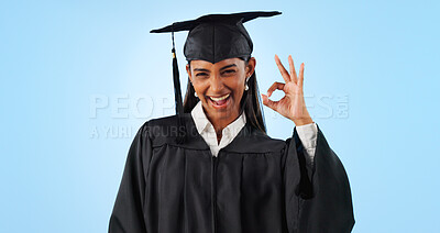 Woman, ok sign and smile for graduation in studio with review with vote, choice or support by blue background. Student girl, portrait and celebration for icon, emoji or decision for success with goal