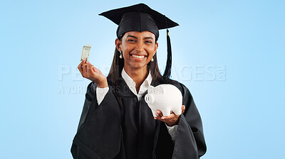 Woman, graduation and piggy bank in studio, money or saving for investing, future or portrait by blue background. Student girl, banking and cash for education, decision or choice for financial wealth