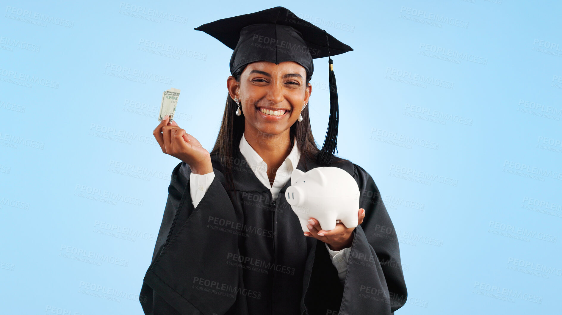 Buy stock photo Woman, graduation and piggy bank in studio, money or saving for investing, future or portrait by blue background. Student girl, banking and cash for education, decision or choice for financial plan