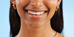 Teeth whitening, closeup of dental and woman with smile for oral care, wellness and mouth on blue background. Beauty, hygiene and orthodontics with skin, cosmetics and healthy in studio with veneers