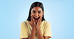 Excited, woman and crazy portrait with wow, surprise and winner with a smile in a studio. Blue background, happy and celebration with female person with motivation from announcement and achievement