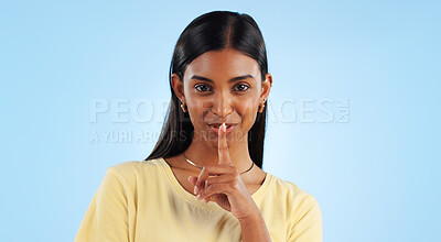 Buy stock photo Woman, finger to lips and secret in portrait with gossip, news or announcement on blue background. Silence, gesture and emoji in studio, whisper for privacy and confidential information with sign