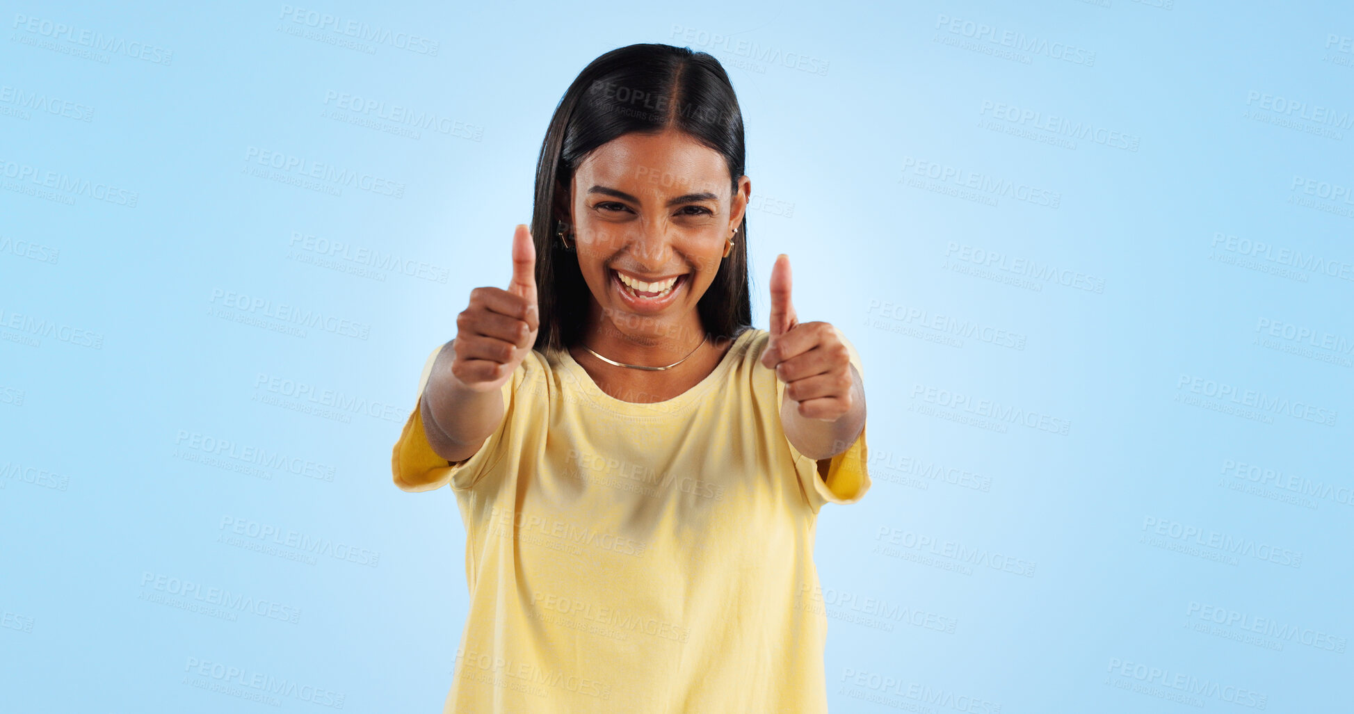 Buy stock photo Woman, happy in portrait and thumbs up for agreement, success or support with hand gesture on blue background. Like, yes and emoji with feedback, vote or opinion in studio with thank you or praise
