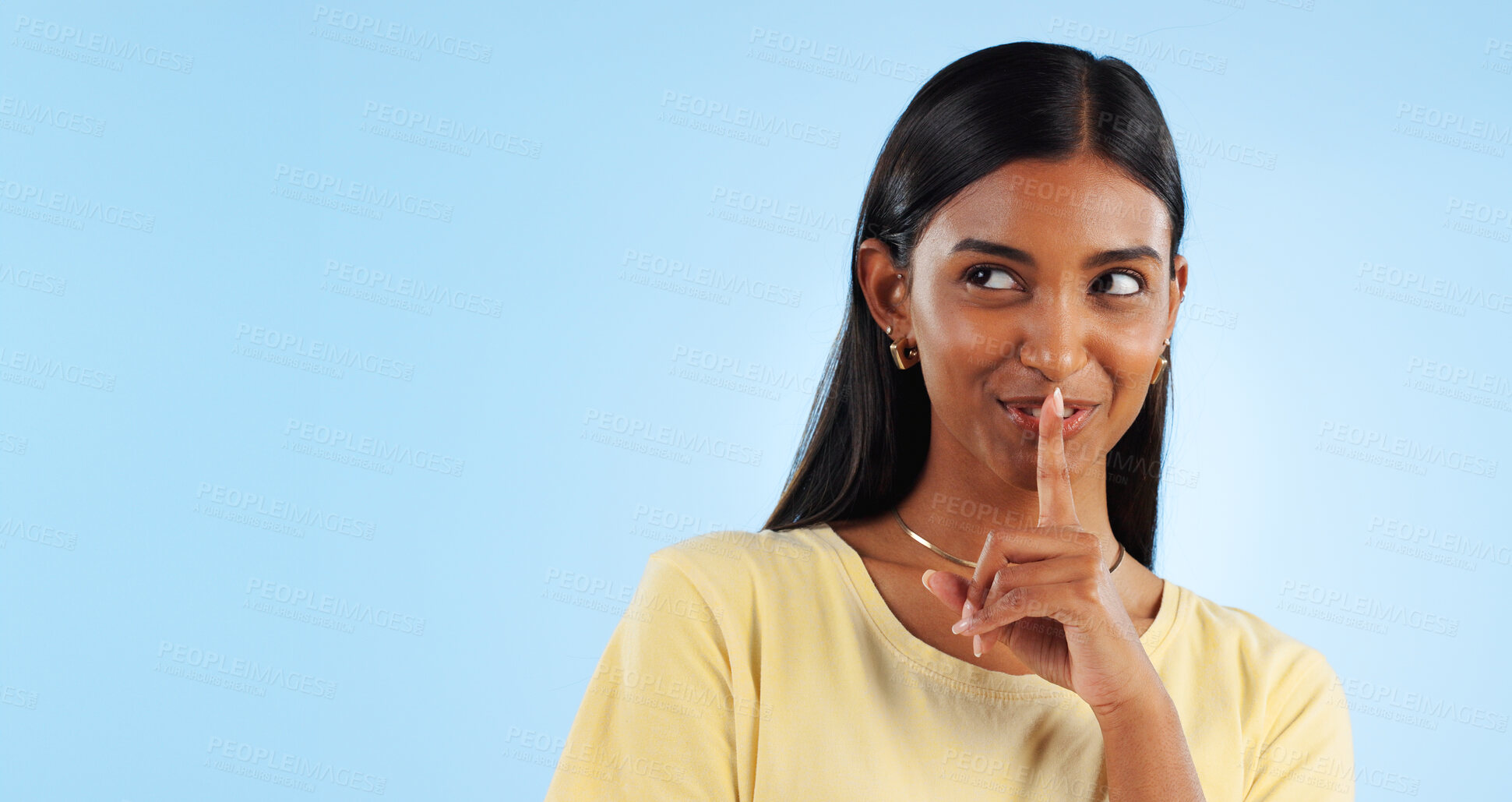 Buy stock photo Secret, gossip and woman with finger on lips, smile and announcement on a blue background. Person, girl and model with privacy, mockup space and drama news with surprise, emoji and whisper with shush