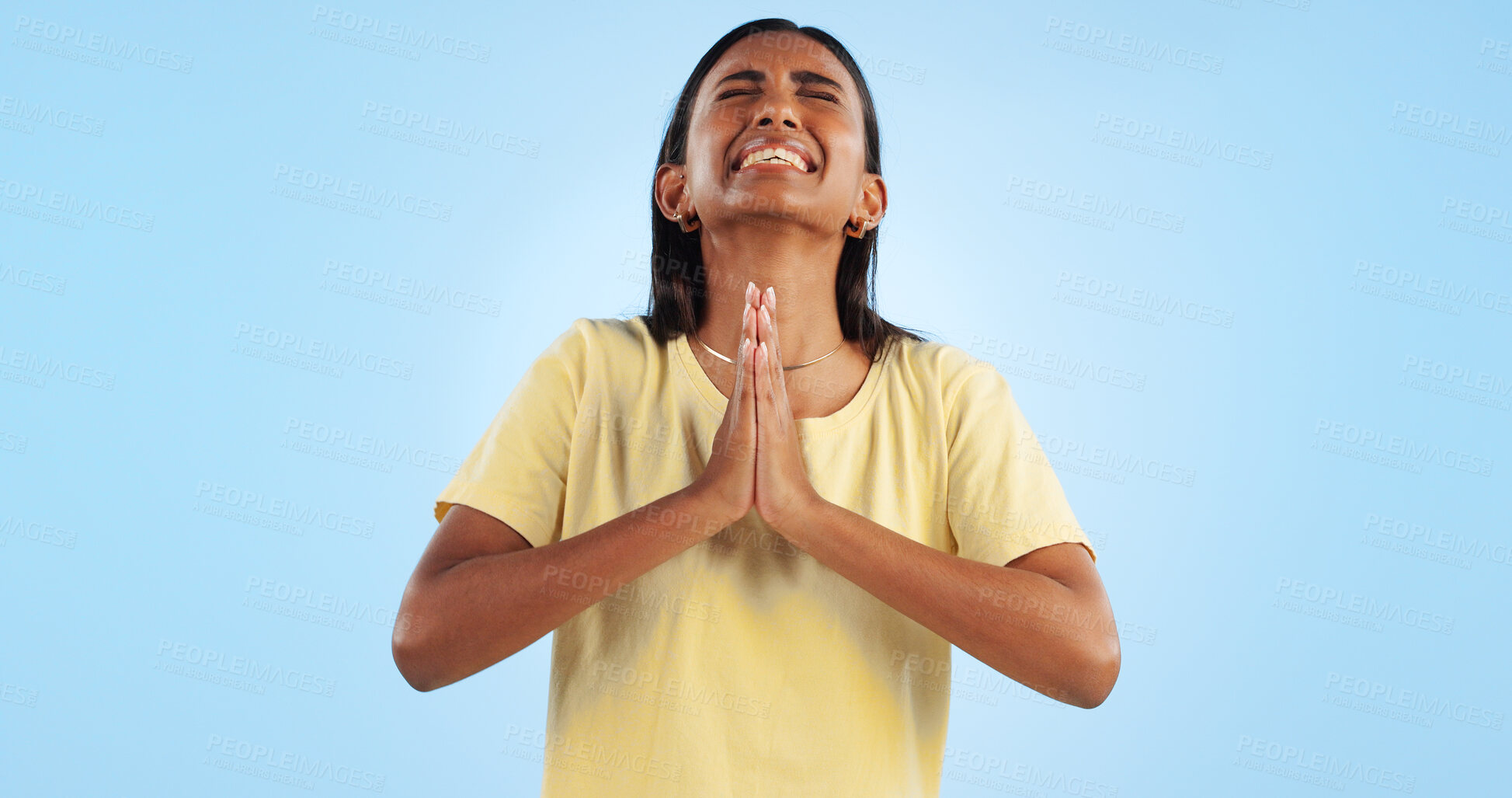 Buy stock photo Woman, praying and worship for faith and religion in studio, guide with help and trust God on blue background. Desperate, anxiety and prayer, sorry or forgiveness with pain, gratitude and spiritual