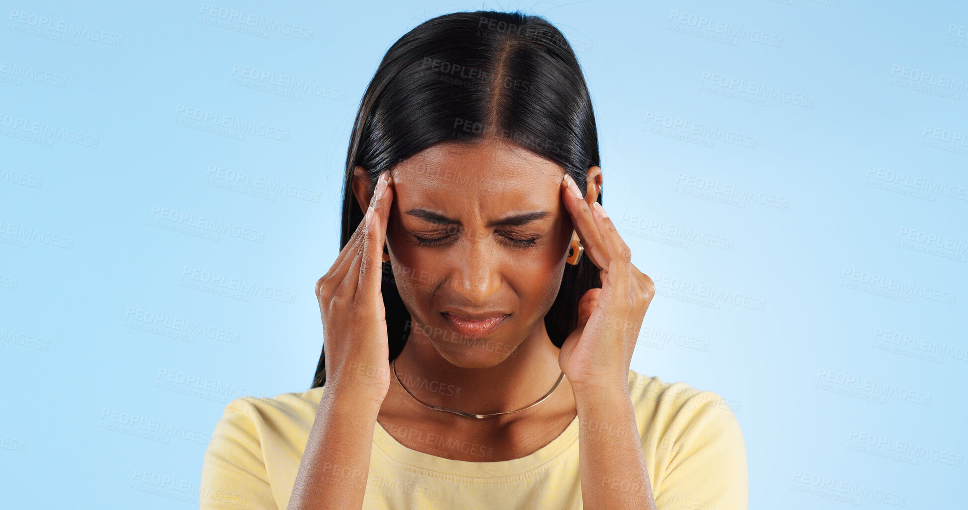 Buy stock photo Headache, pain and burnout, woman with fatigue in studio with health emergency and wellness on blue background. Migraine, brain fog and vertigo from medical condition with burnout, sick and tired