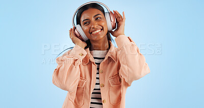 Buy stock photo Happiness, woman and headphones, listening to music in studio and entertainment on blue background. Mockup space, audio streaming and fun with dancing, energy and freedom with wireless tech and sound