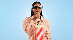 Woman, cinema and 3D glasses with popcorn, streaming and entertainment with vision on blue background. Theater corn snack, film or movie with user experience, television and holographic in studio