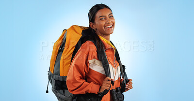 Hiking studio, backpack and happy woman trekking, backpacking and travel gear for fitness, adventure or tourism holiday. Camping bag, equipment and person smile for trip journey on blue background