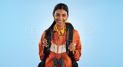 Hiking studio, portrait and happy woman trekking, backpacking and travel for fitness, adventure or tourism holiday. Active camper, smile or Indian person vacation, freedom or break on blue background